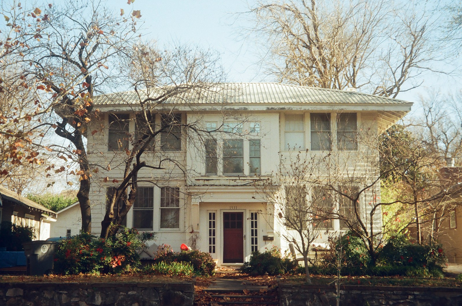 white and brown concrete building near trees during daytime, home