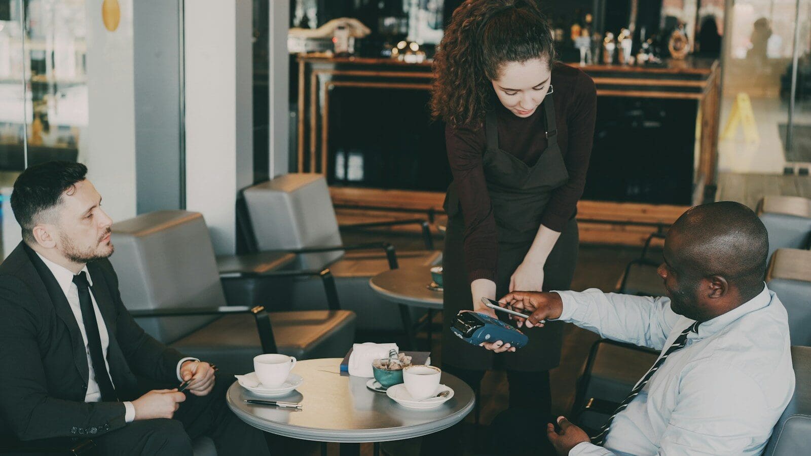 Customer paying with credit card at cafe counter